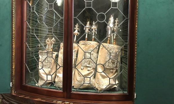 Torahs in a leaded glass and dark wood case