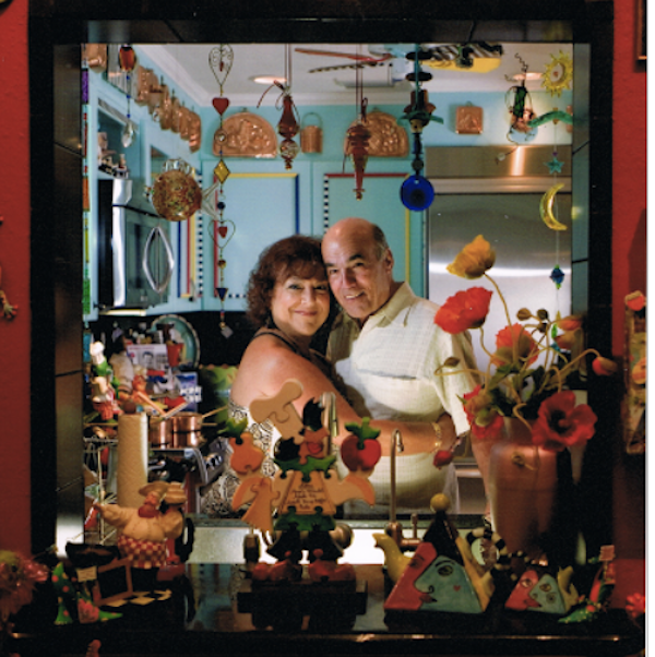 Looking in to a kitchen from a pass through at a loving couple