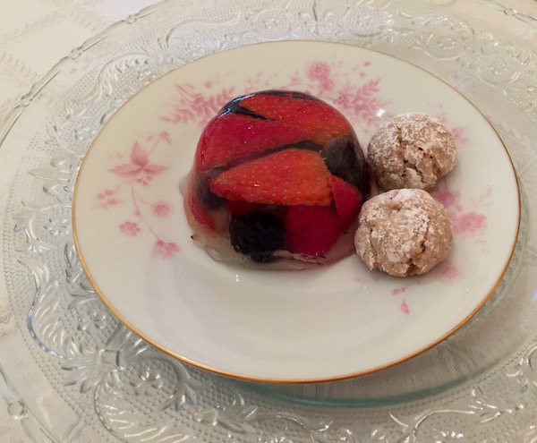 A white plate with pink flowers topped with Summer Fruit, Rose and Champagne Jellies with Hazelnut Crinkles