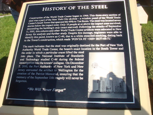 A large sign with writing explain the 9/11 memorial steel