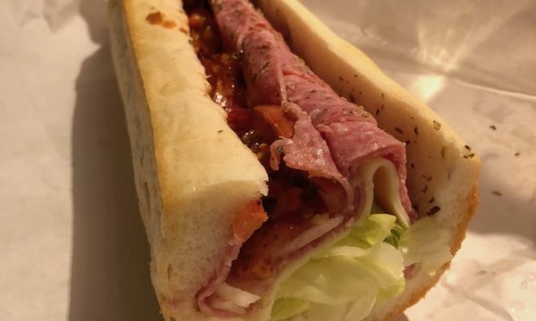 Half of an Italian sub on butcher paper
