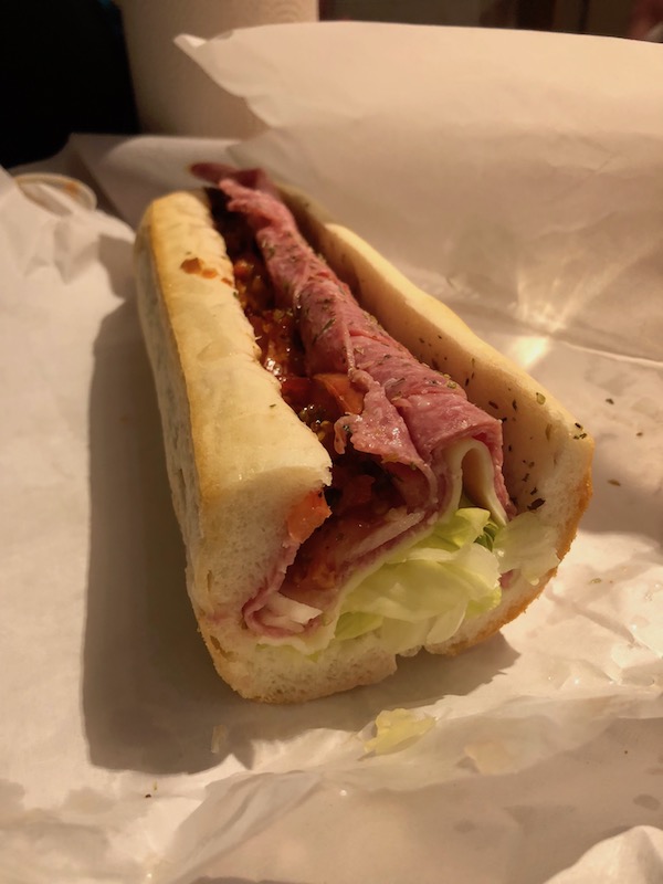 Half of an Italian sub on butcher paper