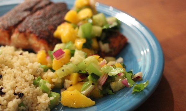 A blue plate withWild Copper River Salmon With Mango Tomatillo Salsa