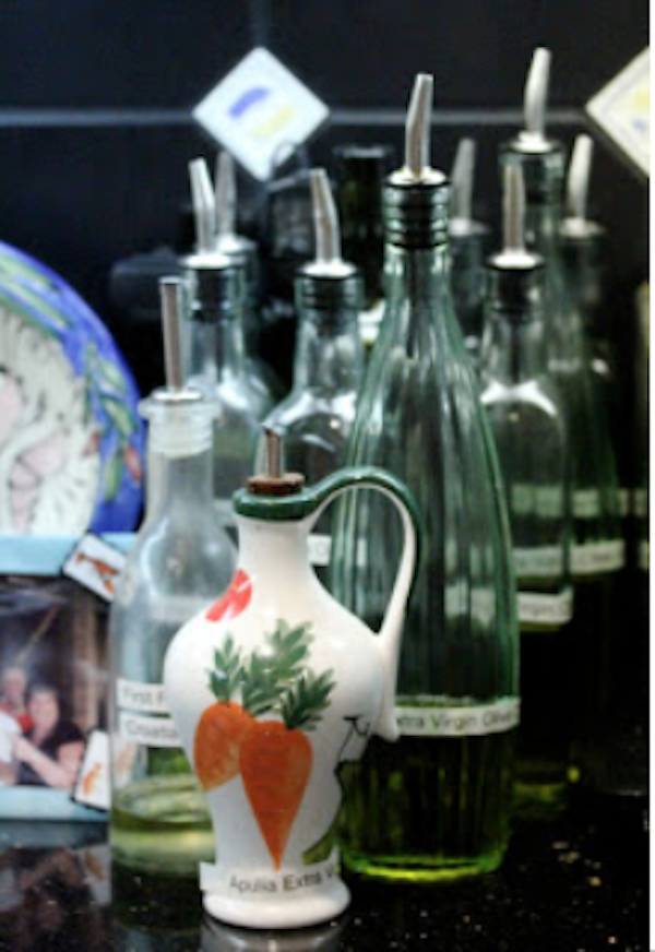 A grouping of assorted bottles of olive oils