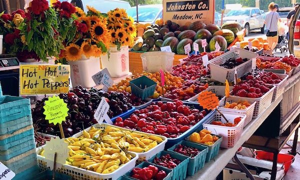 Bins of peppers in assorted colors and shapes at the Raleigh Farmers Market.