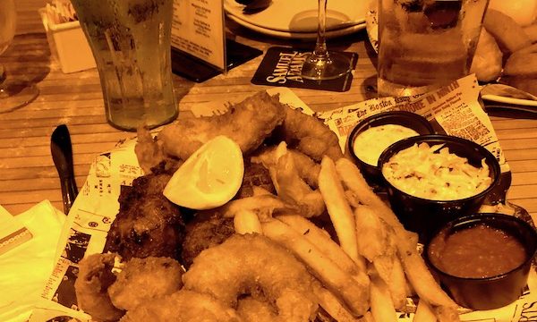 Fried shrimp, fish, conch fritters, fries, sauces and coleslaw at Bostons on the Beach in Delray Beach Florida
