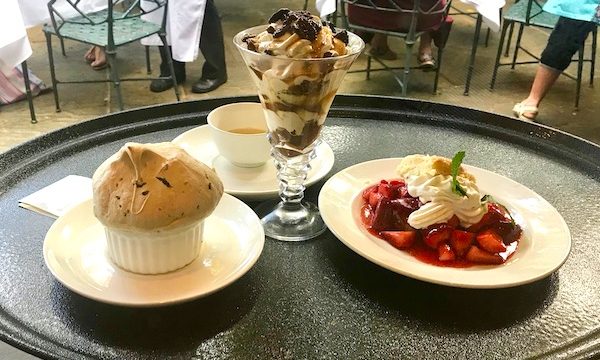 A waiters tray holding three desserts at Jazz Brunch at Commander's Palace