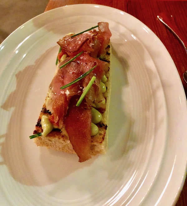 A white oval plate topped with a toast cover with ahi tuna, tomato and avocado at Bywater American Bistro in New Orleans