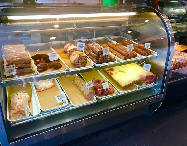 A meat case filled with steak and sausages where we had our Lunch at Cochon Butcher in New Orleans