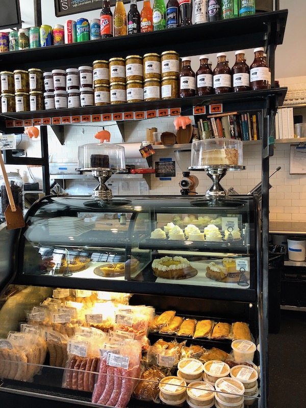 A meat case and a sheep with jars of condiments where we had Lunch at Cochon Butcher in New Orleans
