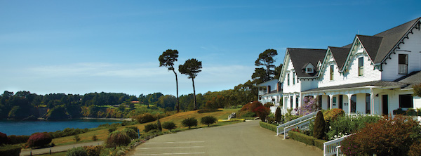 A white building and lush landscape from Spring in Mendocino, California