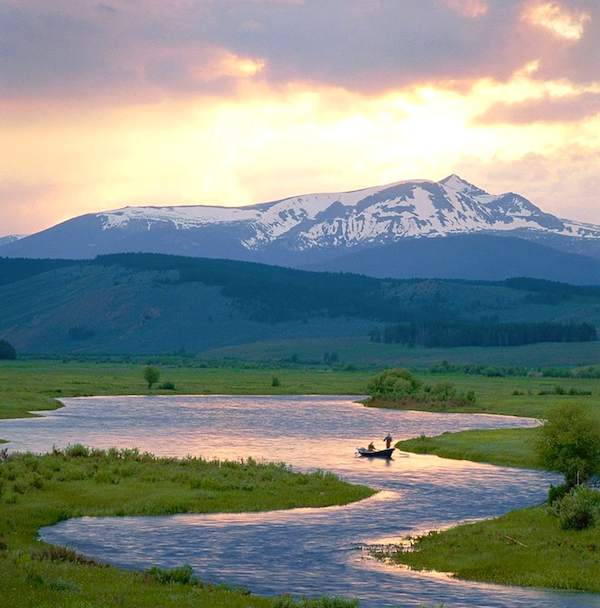 A meandering stream in a valley with snow capped mountain in background from Discover a Taste of Montana