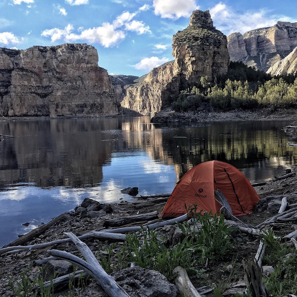 A red tent in a canyon surrounded by rock formations from Discover a Taste of Montana