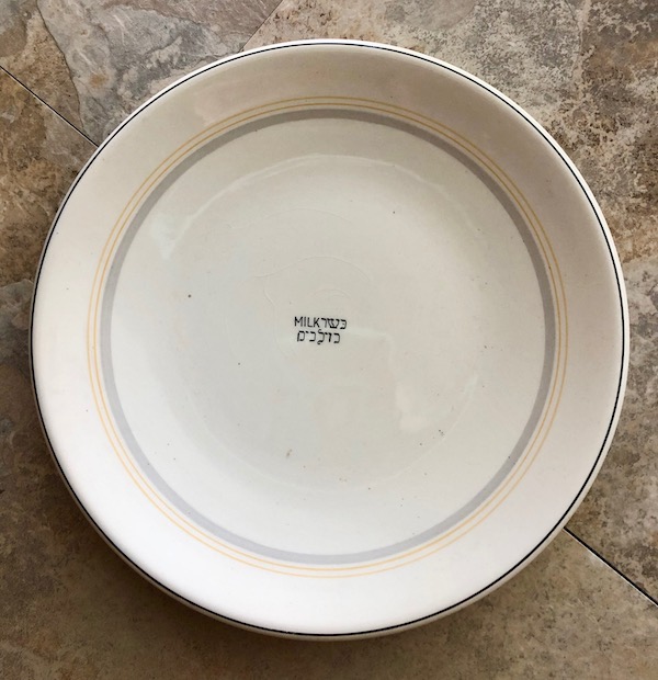Exciting News About Cunard's Queen Mary a cream colored plate with the word milk in English and Hebrew.