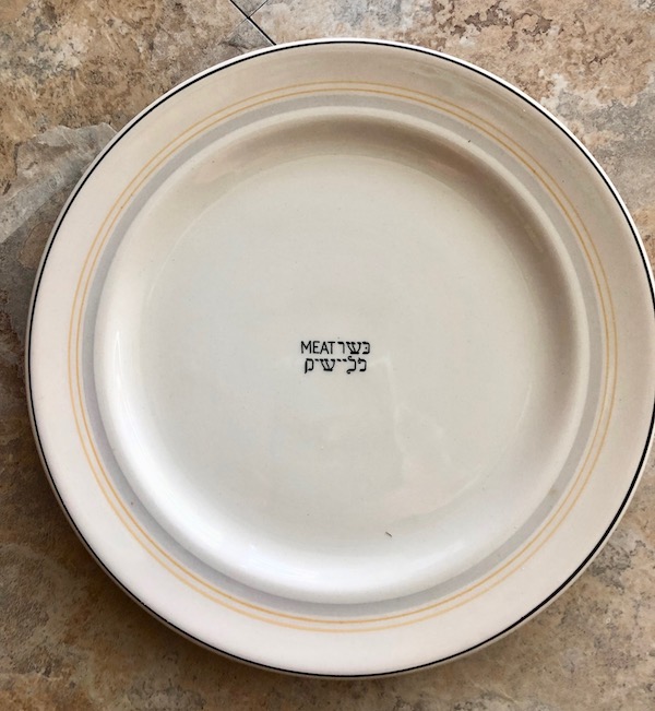 Exciting News About Cunard's Queen Mary a cream colored plate with the word Meat in English and Hebrew.