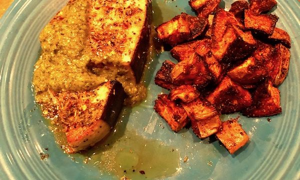 Sicilian Swordfish with Tomatillo Salsa and roasted sweet potatoes on a turquoise plate.