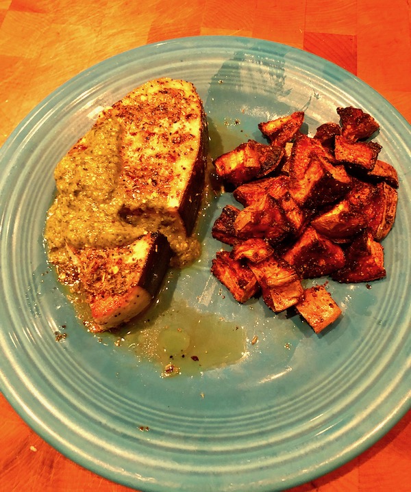 Sicilian Swordfish with Tomatillo Salsa and roasted sweet potatoes on a turquoise plate.