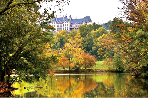 The Biltmore Hosts Downton Abbey Exhibit showing the Biltmore with the lagoon in the foreground.