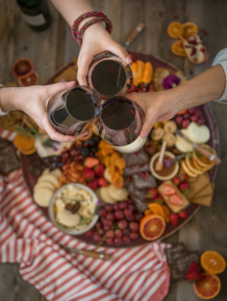 A board covered with fruit, cheese and wine from California Wine Country