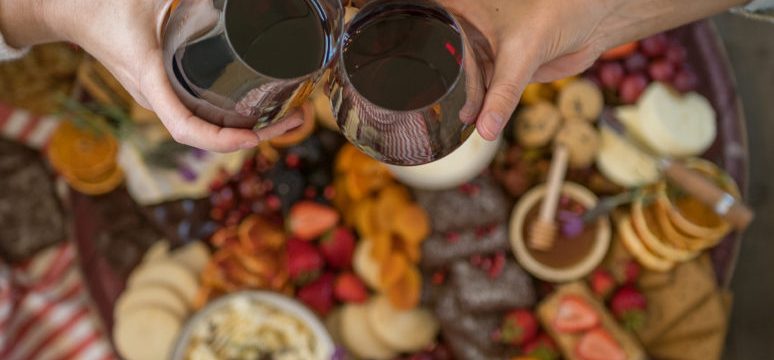 A board covered with fruit, cheese and wine from California Wine Country