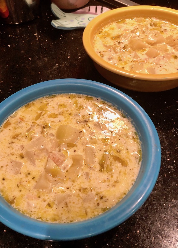 Two soup bowls filled with New England Clam Chowder.
