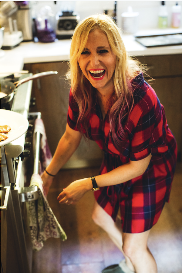 A woman in a red and black plaid dress in a kitchen from One Dish - Four Seasons