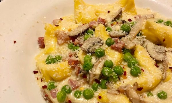 A white soup bowl filled with pasta, mushrooms, peas and parsley at Red Room in Ventnor NJ