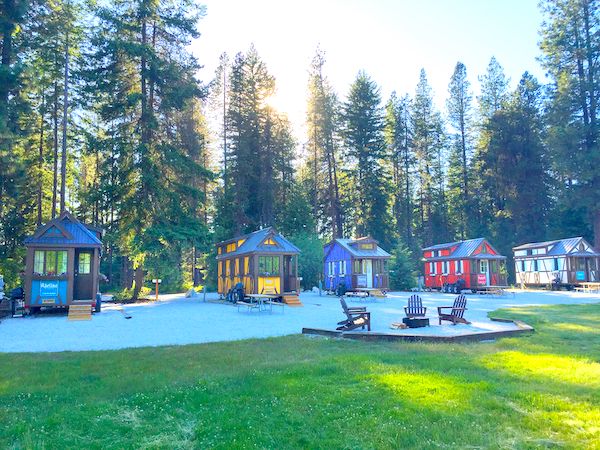A row of colorful tiny houses nestled in the woods from Authentic Oktoberfest - No Passport Required