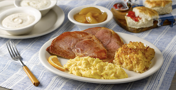 A huge breakfast of scrambled eggs with ham and biscuits, apples and grits from Cracker Barrel Restaurants turn 50!