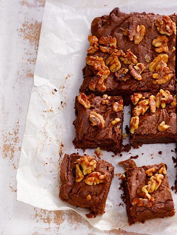 A white platter of brownies with nuts from Squeezable Mighty Sesame Tahini