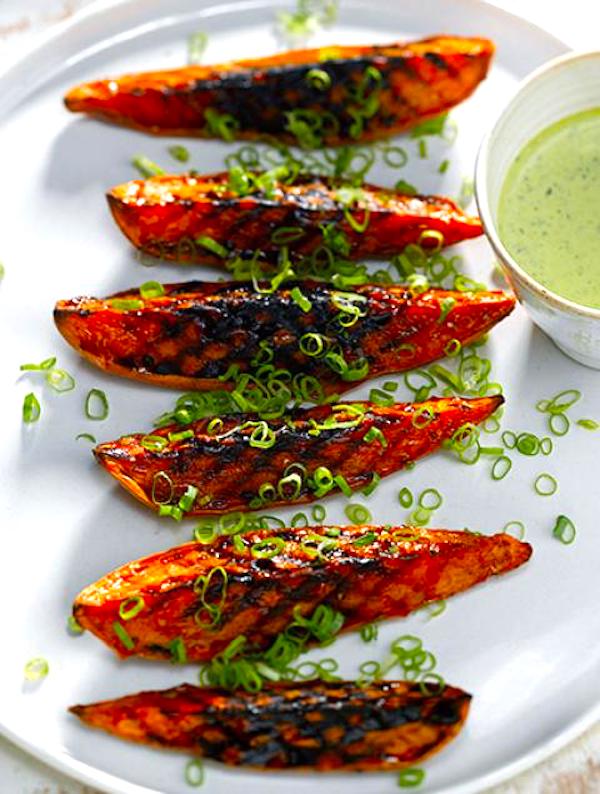 A white platter topped with grilled sweet potato wedges and parsley from Squeezable Mighty Sesame Tahini
