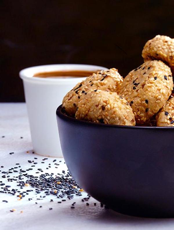 A navy bowl filled with cookies from Squeezable Mighty Sesame Tahini
