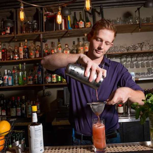 A bartender pouring a drink from Legacy of Art, Craft and Food in Asheville NC
