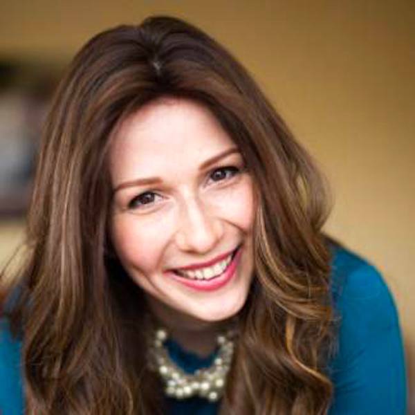 A head shot of a woman with long dark hair and a blue sweater from Pulled Brisket Taco Latke for Hanukkah