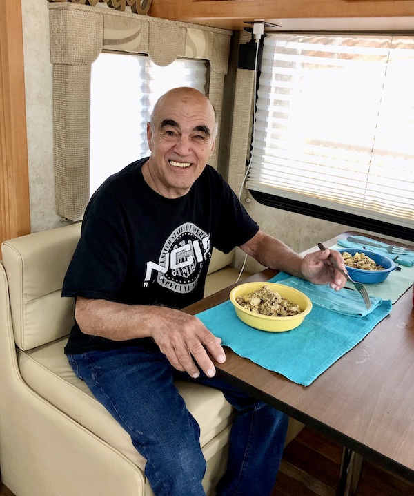 A man in a black T-shirt sitting in a booth with ready to eat a breakfast bowl at our 1st Stop - Greensboro, Georgia