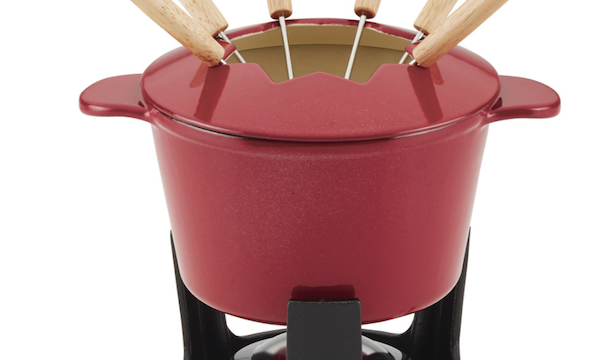 A red fondue pot with forks on a black stand is one of the Best Valentine's Gifts for Cooks