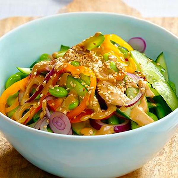 An aqua bowl piled high with cucumber salad