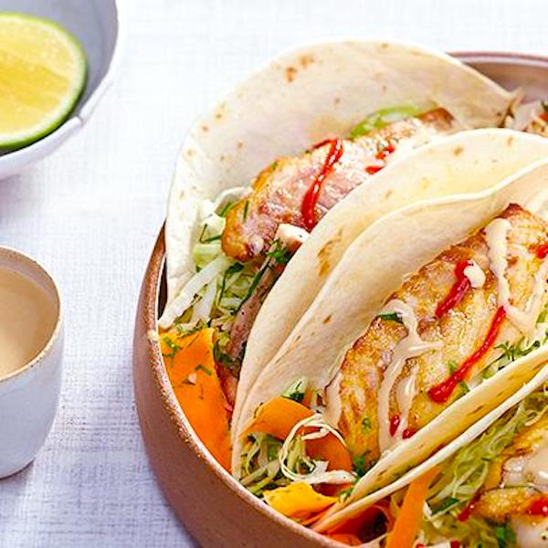 A plate topped with fish tacos for a Super Bowl party.