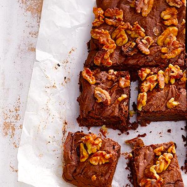 Walnut topped brownies on parchment are a perfect dessert after Chicken Breast Tahini Drizzled Hero for Super Bowl