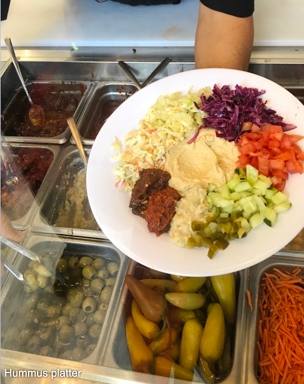 The hummus platter atop many dishes of ingredients from Friendship Café on Las Olas