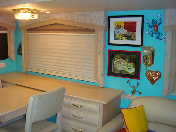 An RV dinette with turquoise walls from Happy Campers