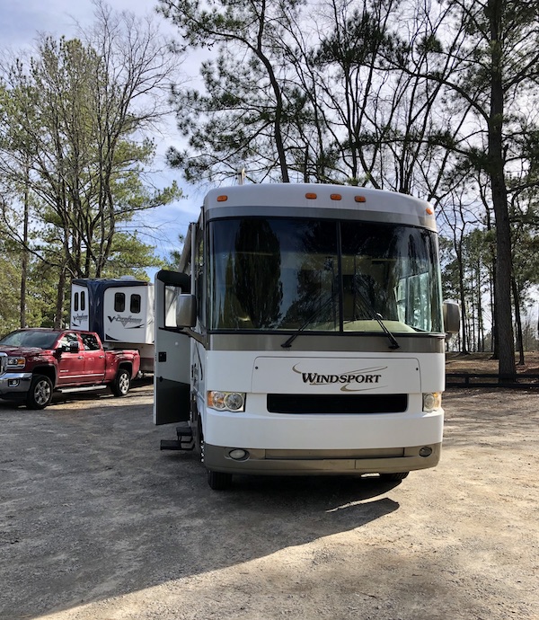 The front of a white and tan RV from Happy Campers