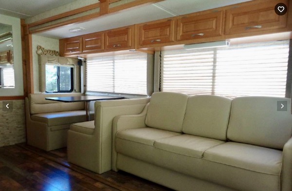 A sofa and dinette in an RV from Happy Campers