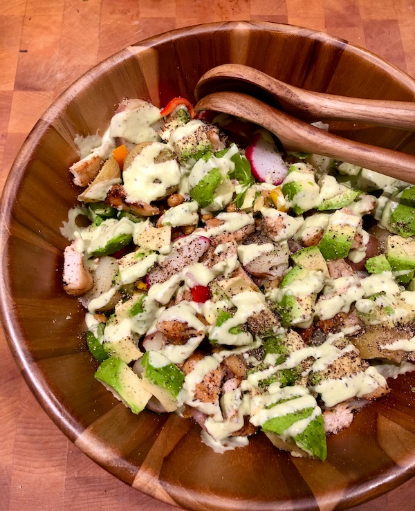 A Healthful Chicken Salad with Creamy Yogurt Dressing in a wood bowl