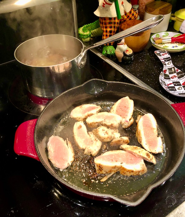 Chicken slices cooking in a red enamel cast iron pan for Healthful Chicken Salad with Creamy Yogurt Dressing