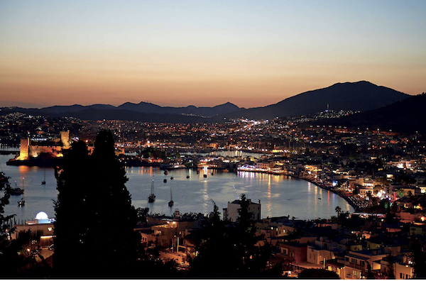 A lake surrounded by mountains and buildings from Anatolia Adventures in Turkish Eating