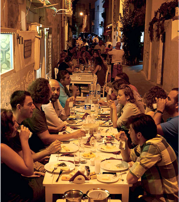 People enjoying a meal at a long table from Anatolia Adventures in Turkish Eating