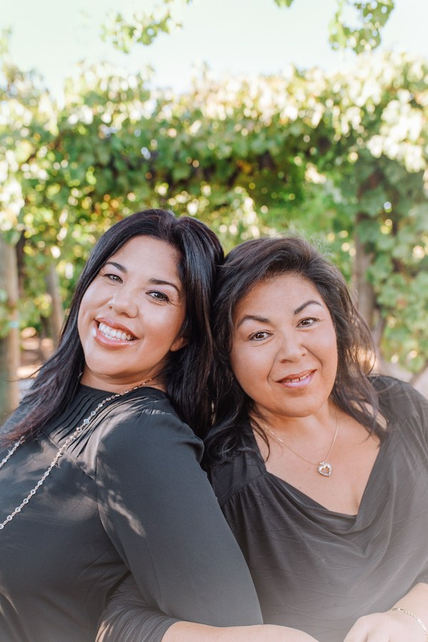 Two women in dark gray