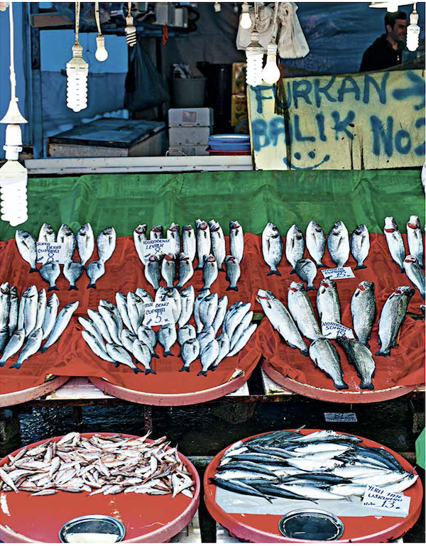 Terracotta dishes with red cloth and assorted fish for sale from Istanbul Cult Recipes