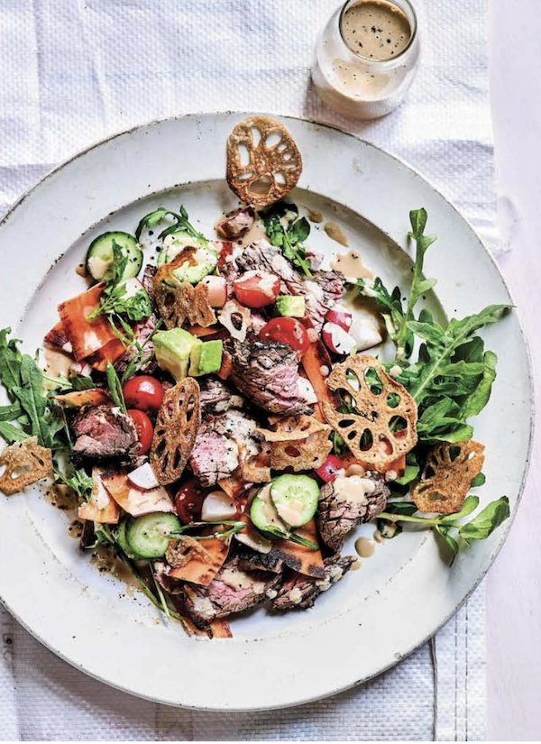 A white plate topped with a beef salad and fried lotus root slices from My Asian Kitchen